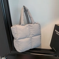 Light grey quilted puffer shoulder bag with soft padded handles and boxy design - Gray