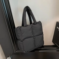 Black quilted puffer tote bag with wide handles and padded nylon finish in casual style - Black