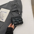 Mini black quilted shoulder bag with heart lock and chain strap on grey blazer - Black Small
