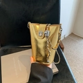 Chic golden metallic bucket bag with a clasp closure and a sleek chain shoulder strap - Gold