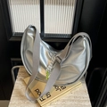 Silver crescent moon shoulder bag with wide strap and neon green woven puller accents - Silver