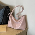 Pink faux leather underarm bag with embossed text and decorative knotted shoulder strap - Pink