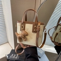 Chic beige and brown crossbody bucket bag with butterfly relief and a puppy charm - With Puppy Pendant / Off White