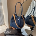 Deep blue denim bucket bag with brown leather handle reflected in a circular mirror - Dark Blue