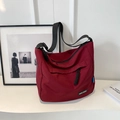 Large burgundy nylon tote bag with black wide strap and multi-pocket design for travel - Burgundy