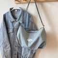 Light blue nylon tote bag with iFashion patch and adjustable strap on denim jacket - No Pendant / Blue