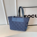 Blue quilted tote bag with large diamond stitching and leather logo patch detail - Blue