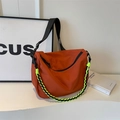 Orange nylon crossbody dumpling bag with wide shoulder strap and neon green woven chain - Brown