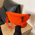 Bright orange canvas crossbody chest bag with adjustable strap and small round pouch - Orange