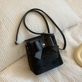 Black velvet bucket bag featuring a large decorative bow and slim leather shoulder strap - Black