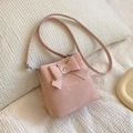 Chic pink bucket bag with a large bow detail and adjustable silver shoulder strap - Pink