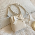 Creamy white bucket bag with large bow detail and adjustable shoulder strap - Off-white
