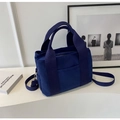 Detail of dark blue canvas tote bag showing wide handles and outer slip pocket - Blue