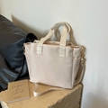 Minimalist beige nylon tote bag with adjustable shoulder strap and water-resistant finish - Off White