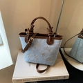 Retro denim bucket bag with white floral embroidery and dark brown leather accents - Blue