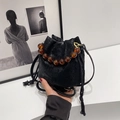Black wrinkled bucket bag with amber beaded handle and drawstring closure for women - Black