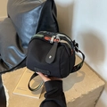 Black canvas crossbody bag featuring colorful floral woven shoulder strap and zipper - Black