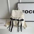 Cream velvet backpack featuring black silk bows and embroidered Nika branding - Off White