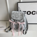 Detail of silver velvet backpack featuring pink satin bows and embroidered text - Silver