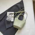 Chic light green lychee leather bucket bag with top handle and adjustable shoulder strap - Without Pendant / Green