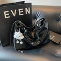 Minimalist black tote bag with wrinkled texture and cute cloud charm on leather bench - With Cloud Pendant / Black