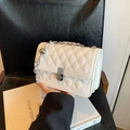 Elegante cremeweiße Stepptasche mit silberner Kette und Metall-Drehverschluss - Weiß
