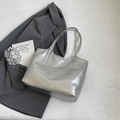 Minimalist silver metallic tote bag shown on a white background with a grey blazer - Silver No Pendant
