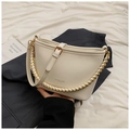 Detail of white leather bucket bag with gold chain handle and brand logo on dark blazer - No Pendant / White