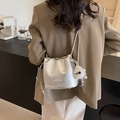 Silver chain bucket bag with metallic leather texture and white plush pendant accessory - Silver