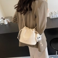 Chic beige bucket bag for women with metal chain strap and cute plush toy pendant charm - Off-white