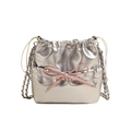 Silver metallic bucket backpack with pink bow detail and dual chain straps on white background - Small / Silver