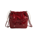 Fashionable red shiny leather bucket backpack with bow detail and silver chain strap - Small / Red