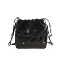Glossy black bucket bag with leather bow detail and silver chain strap on white background - Small / Black