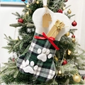 Dettaglio calza di Natale a forma di osso per animali con trama scozzese verde e bordo morbido - Verde