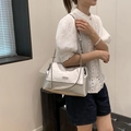 Silver metallic crocodile pattern tote bag with chain strap shown on model's shoulder - Silver