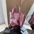 Metallic bright pink bucket bag with a cute silver balloon dog charm and top handles - Pink With Pendant