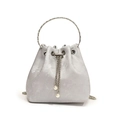 Elegant silver bucket handbag with a metal ring handle and pearl chain tassels - Silver