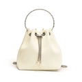 Elegant off-white bucket bag with silver ring handle and pearl drawstring charms. - White