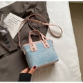 Detail of light blue denim tote with pink leather handles and silver stud hardware - No Pendant / Pink