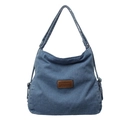 Large blue denim hobo bag with brown leather patch and dual shoulder straps on white background - Light Blue