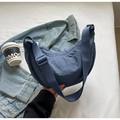 Detail of blue nylon crescent bag with adjustable strap and textured fabric finish - No Pendant / Blue