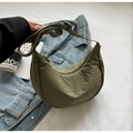 Detail of army green nylon crescent bag with adjustable strap in casual urban setting - No Pendant / Army Green