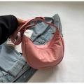 Detailed close-up of pink crescent nylon bag with adjustable strap and zip closure - No Pendant / Pink
