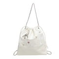 White bucket backpack featuring marble texture, pearl accents, and silver chain straps - Off White