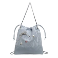 Light blue drawstring bucket bag with pearl details and a rhinestone bow accent - Blue