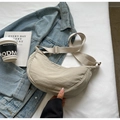 Minimalist beige nylon crescent bag styled with denim jacket and coffee cup - No Pendant / Off-white