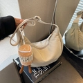 Minimalist beige nylon crescent hobo bag with adjustable strap and plush coffee charm - Cream White With Pendant