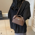 Brown leather crossbody bag with patterned silk scarf handle shown on a model - Coffee