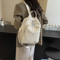 Minimalist cream white leather backpack with large capacity and woven strap detail - Off White
