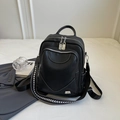 Minimalist black faux leather backpack with silver M logo and geometric woven strap - Black